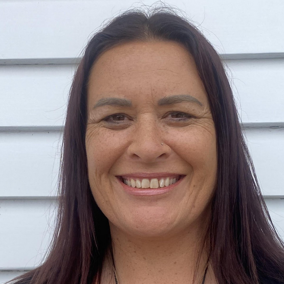 Portrait image of Māori woman with long brown hair smiling Jo-Maitera Hall